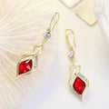 Red Crystal Twisted Geometric Drop Earrings — Gold Tone with Crystal Accent